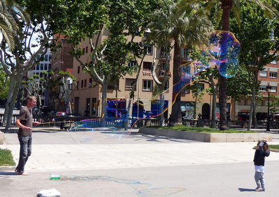 Man with palm trees in city