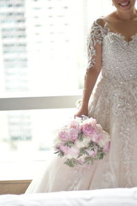 Close-up of woman holding flower bouquet