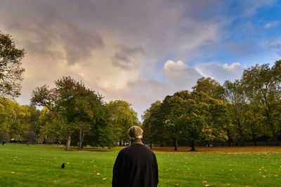 Rear view of woman in park against sky