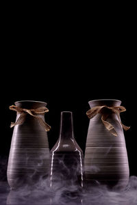 Close-up of glass bottle against black background