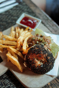 Close-up of burger and french fries on cutting board