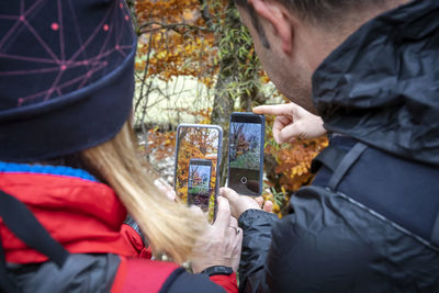 Rear view of man using mobile phone