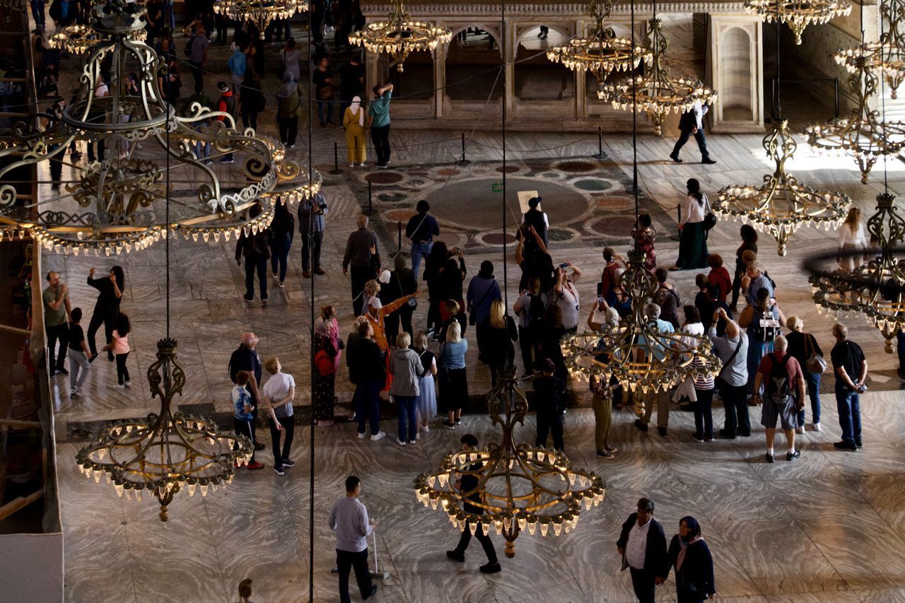 HIGH ANGLE VIEW OF PEOPLE AT CROWD IN BUILDING