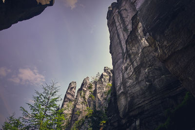 Low angle view of rocky mountains against sky