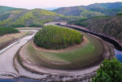 High angle view of road amidst trees and mountains