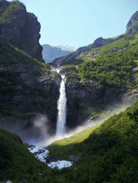 Scenic view of waterfall against sky