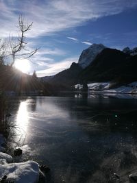 Scenic view of lake against sky during winter