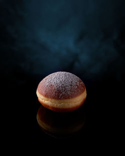 Doughnut on black with dark blue background