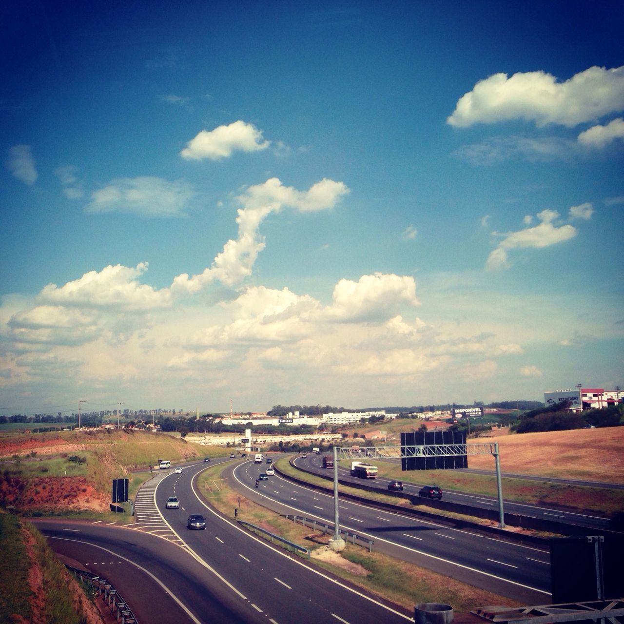 transportation, road, sky, landscape, the way forward, road marking, cloud - sky, blue, vanishing point, diminishing perspective, street, cloud, highway, high angle view, car, nature, outdoors, no people, horizon over land, day