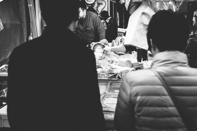 Rear view of people standing at home