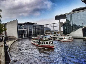 Boats in river with buildings in background