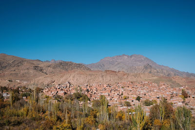 Scenic view of mountains against clear blue sky