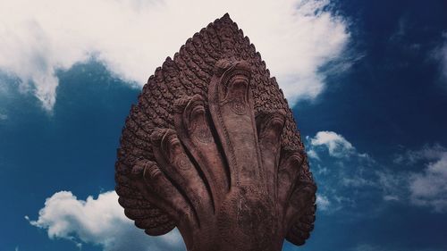 Low angle view of statue seven headed naga serpents against blue sky