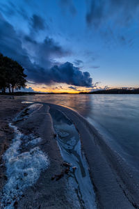 Scenic view of beach against sky during winter