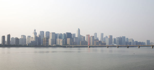 Modern buildings in city against clear sky