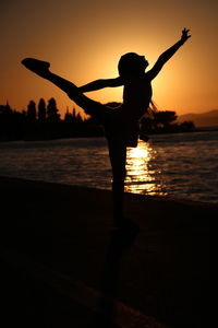 Low angle view of silhouette woman standing by window