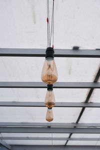 Low angle view of electric lamp hanging on ceiling