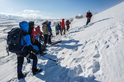 People skiing on snow covered mountain