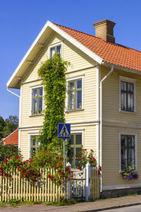 Residential house with blooming roses on a city street