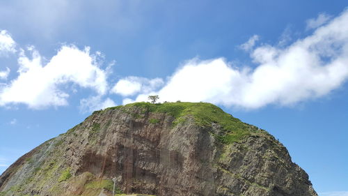 Low angle view of rocky mountain against sky