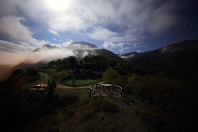 Scenic view of mountains against cloudy sky