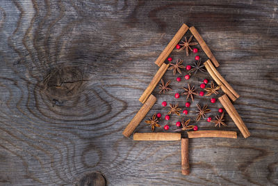 Directly above shot of christmas tree made from spices on wooden table