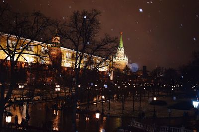 Bridge over river in city at night