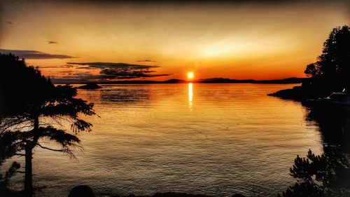 Scenic view of sea against orange sky