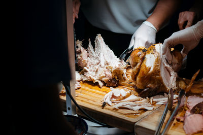 Midsection of person preparing food in plate