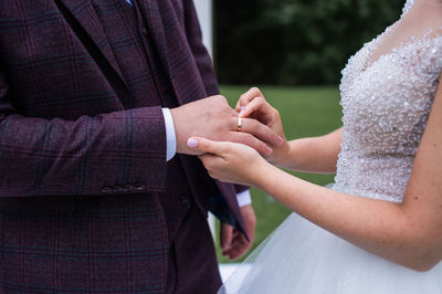 Midsection of couple holding hands