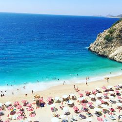 Group of people on beach against sky
