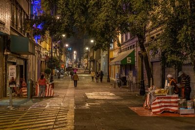 People on street in city at night