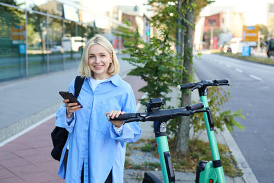 Portrait of young woman using mobile phone