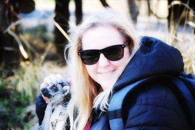 Portrait of smiling woman wearing sunglasses