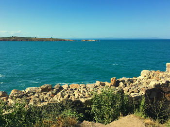 Scenic view of sea against clear blue sky