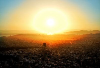 Aerial view of cityscape against sky during sunset