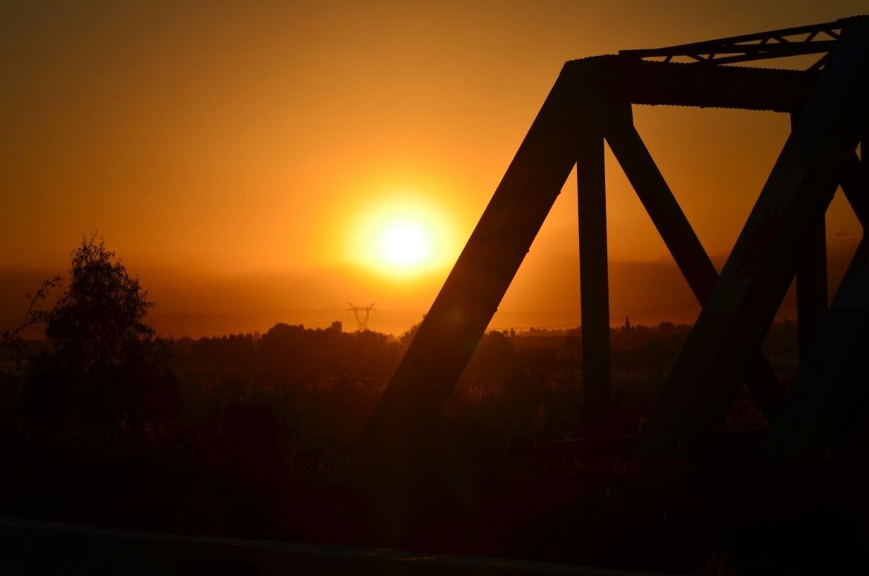 sunset, orange color, sun, silhouette, sky, fence, beauty in nature, sunlight, tranquility, scenics, nature, metal, safety, tranquil scene, protection, idyllic, no people, security, outdoors, built structure