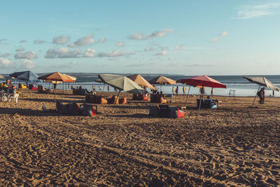 People on beach against sky