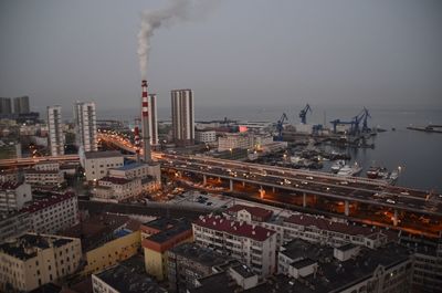 Smoke emitting from factory against clear sky