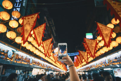 High angle view of people photographing illuminated at night