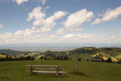 Scenic view of field and mountains against sky