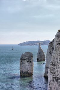 Scenic view of sea and rock formations against sky