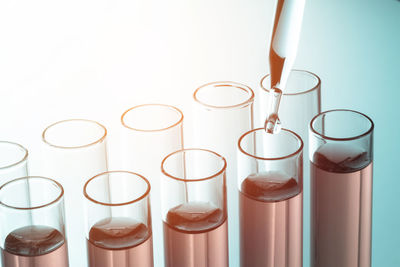 Close-up of test tubes and pipette against white background