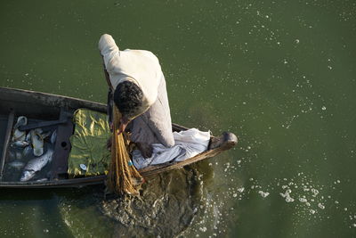 High angle view of man fishing in lake