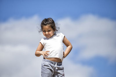 Portrait of smiling girl against sky