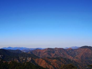 Scenic view of mountains against clear blue sky