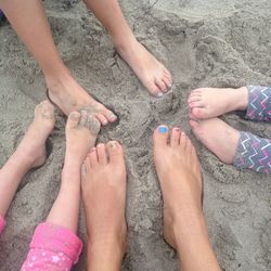 Low section of people on sand at beach