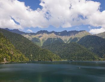 Scenic view of lake by mountains against sky