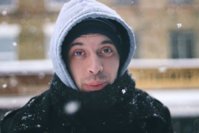 Portrait of man in warm clothing during snowfall