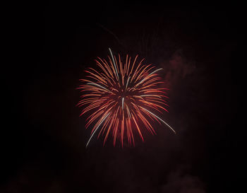 Low angle view of firework display at night